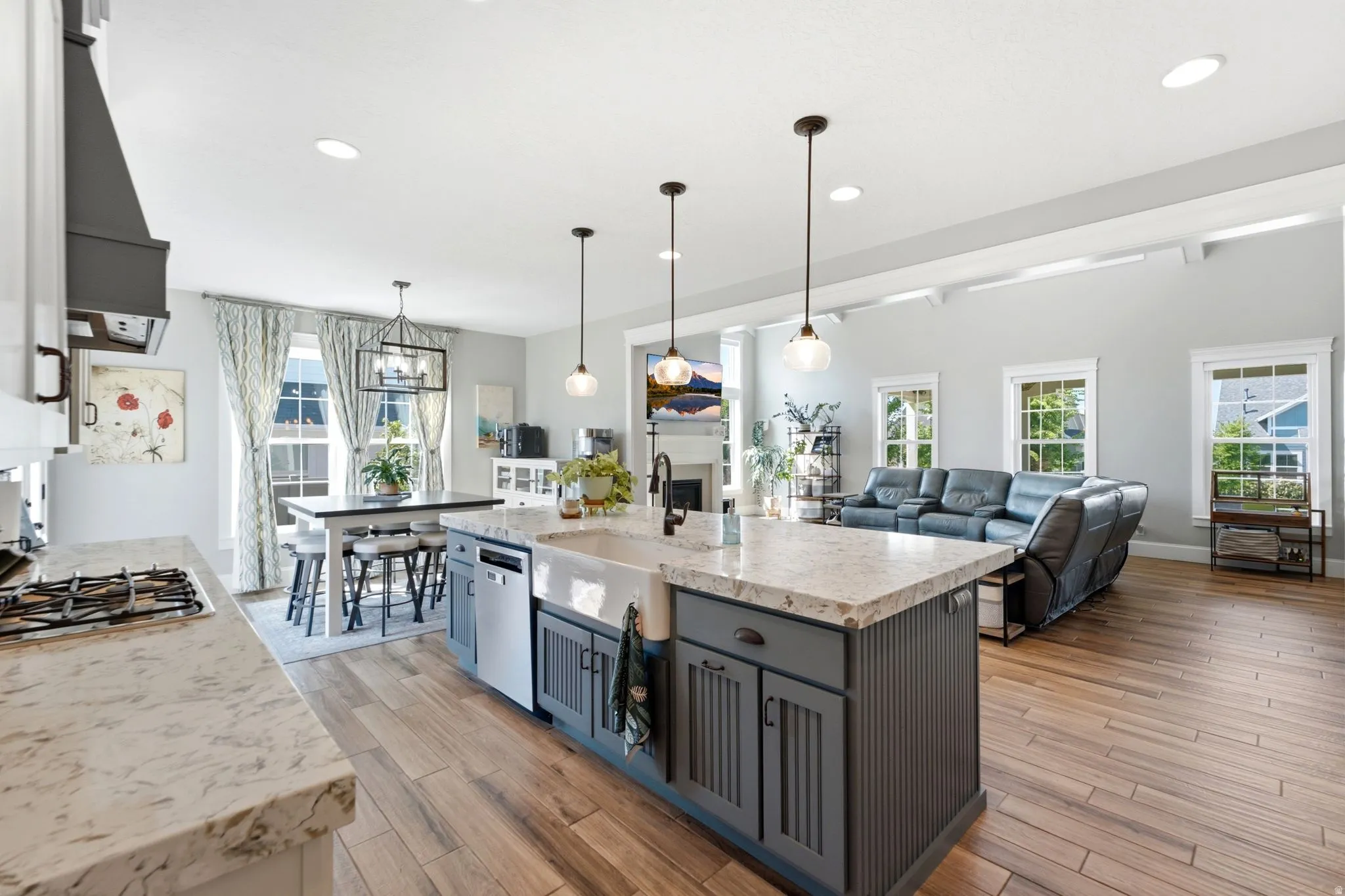 Spacious kitchen featuring a farmhouse sink, bar seating and dining area