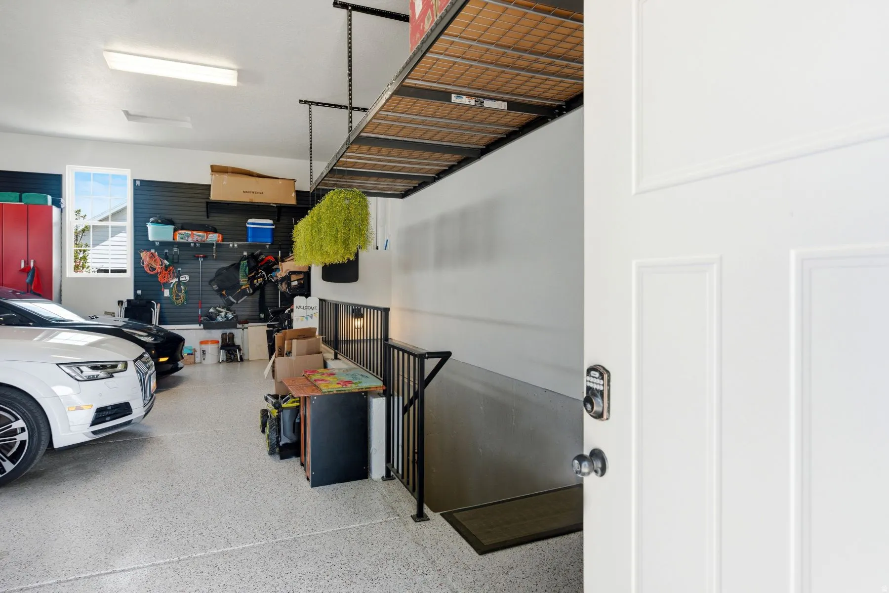 View walking in separate garage entrance with ADU stairs