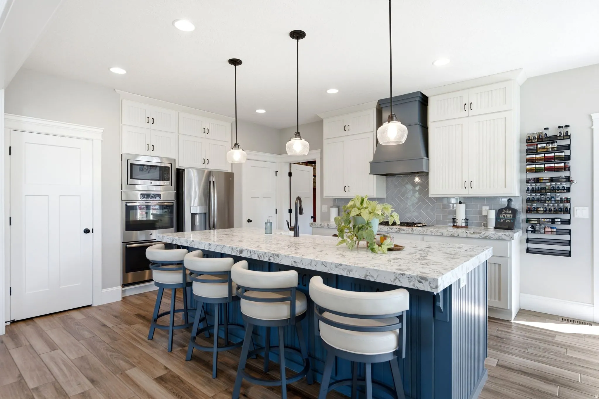 Kitchen showing 2 pantries, double oven, refrigerator and microwave