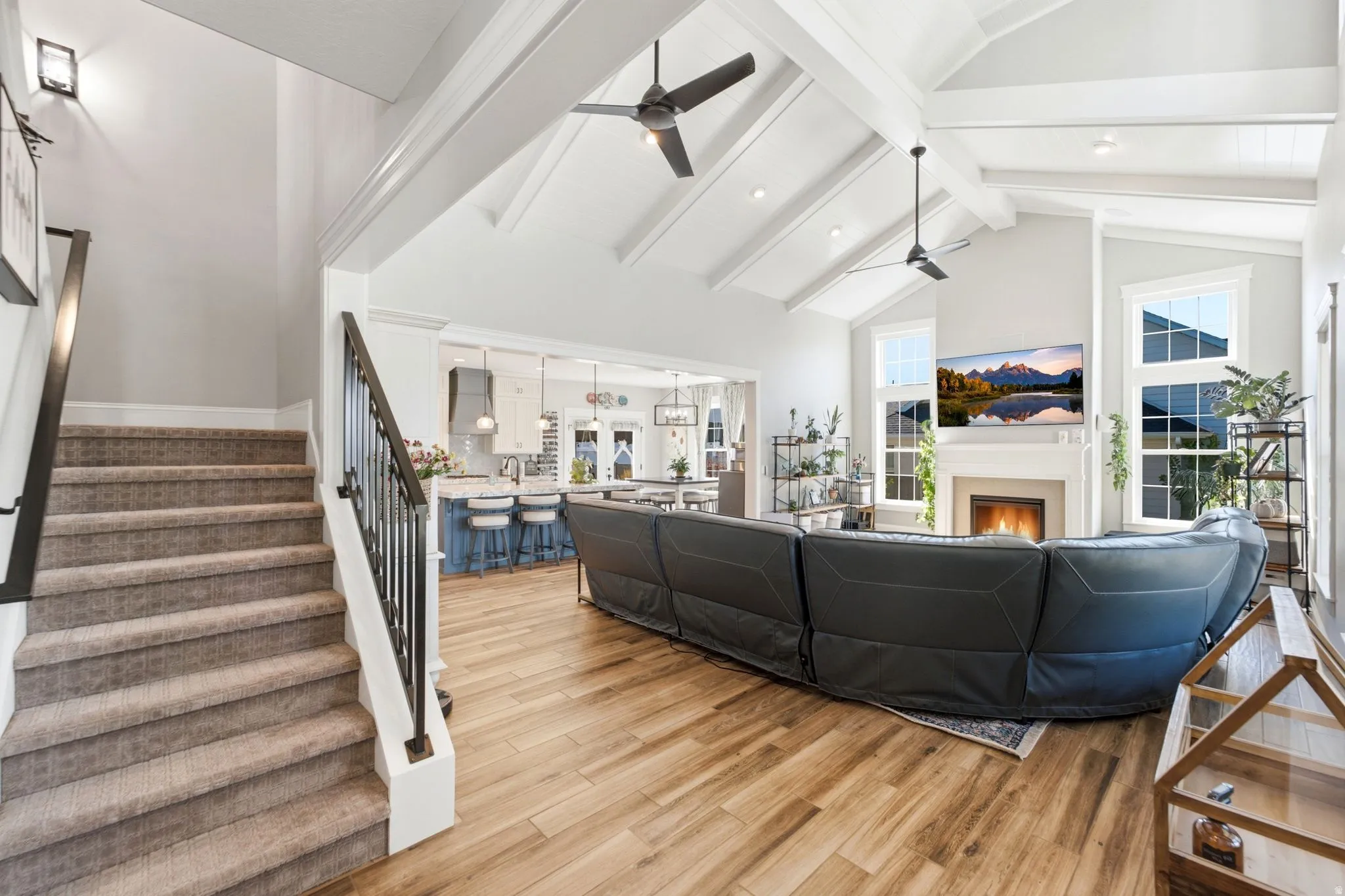 Great room-view of stairs going up and kitchen