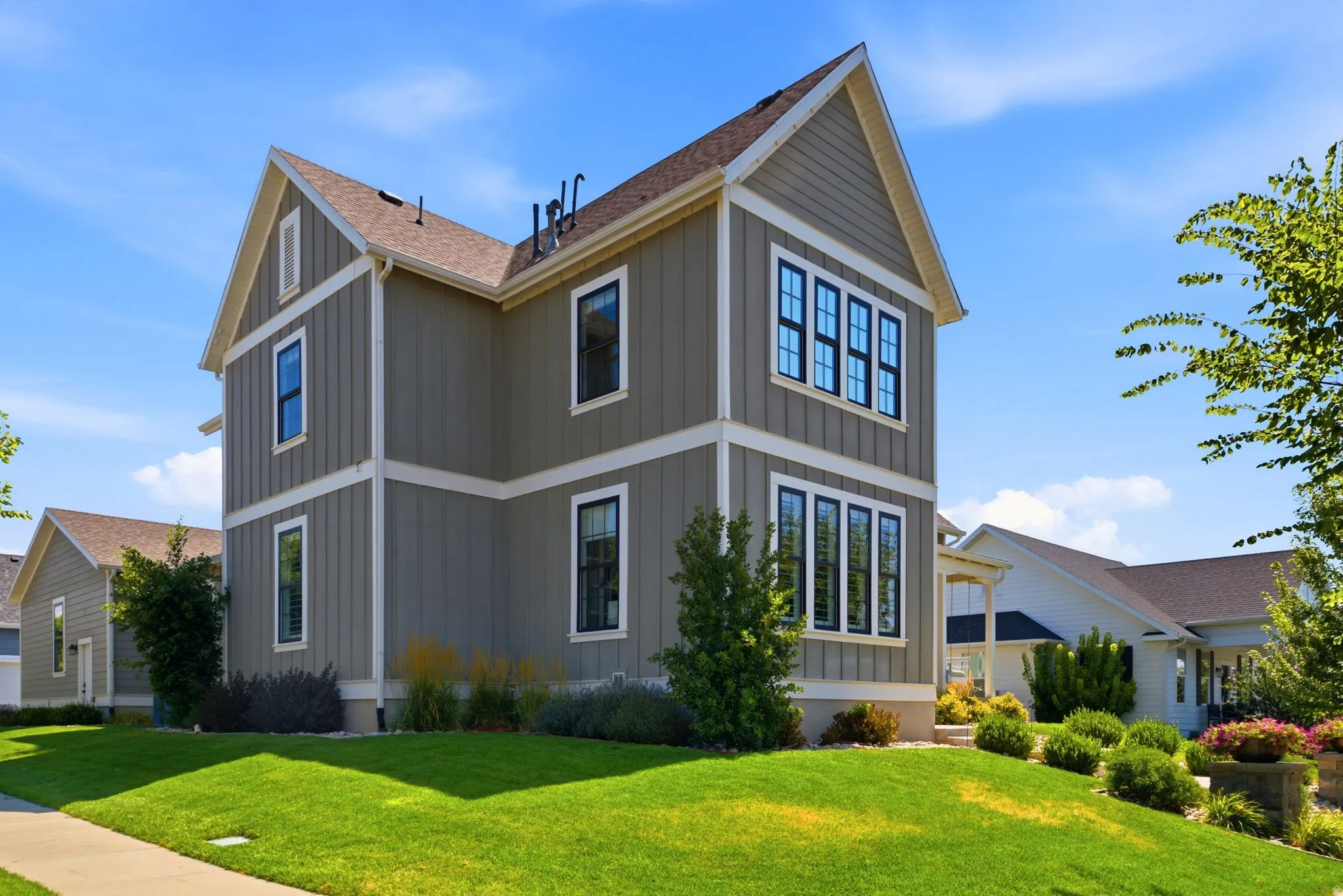Craftsman style architecture featuring vertical board-and-batten siding with white trim