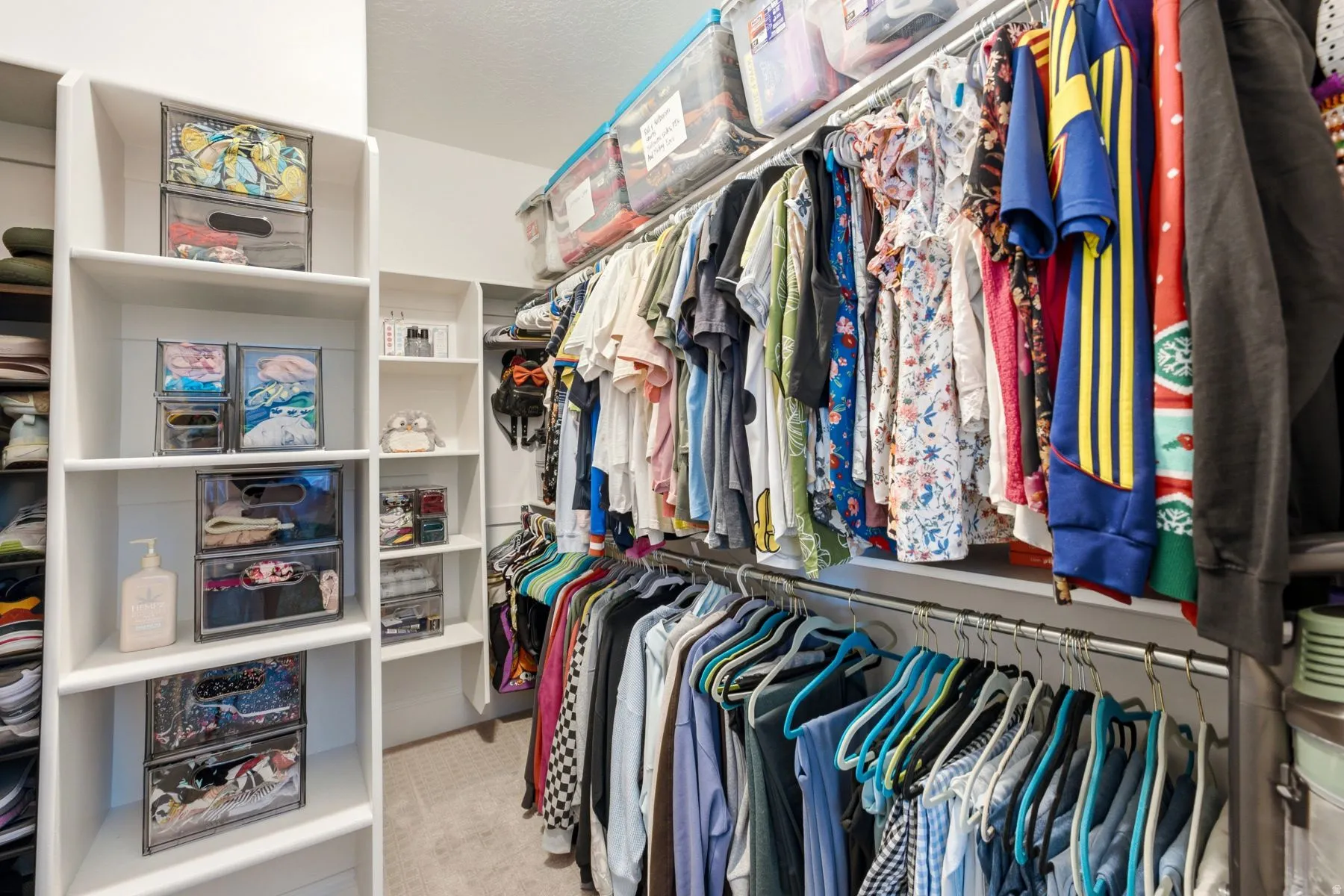 Custom closet system featuring extensive shelving, hanging rods, and integrated storage solutions