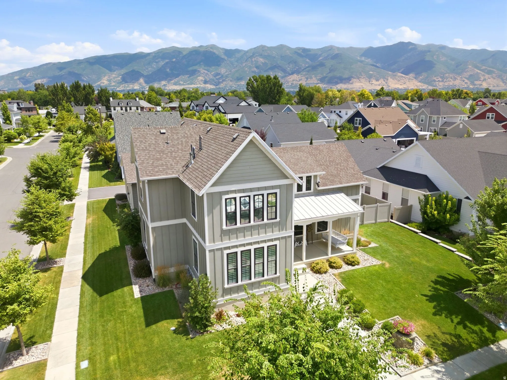 Contemporary two-story residence with a covered porch and side-load garage