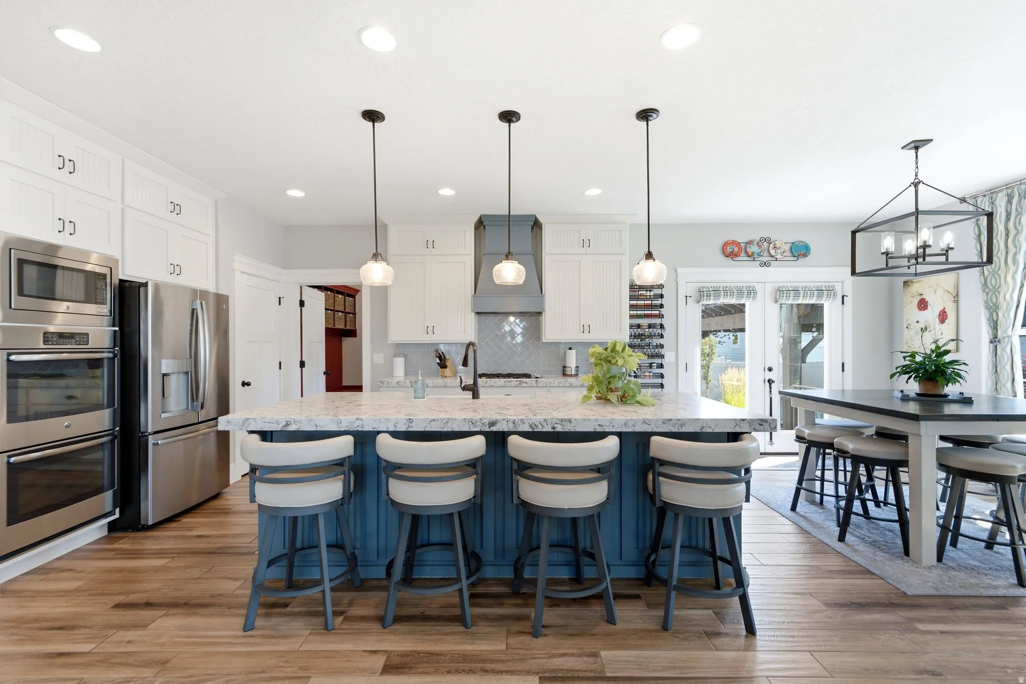 Open kitchen with bar seating and semi-formal dining