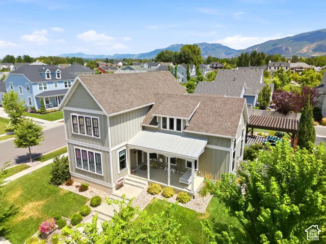 Contemporary two-story residence featuring a covered front porch, light gray siding