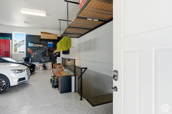 View walking in separate garage entrance with ADU stairs