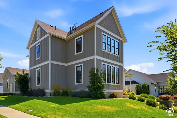 Craftsman style architecture featuring vertical board-and-batten siding with white trim