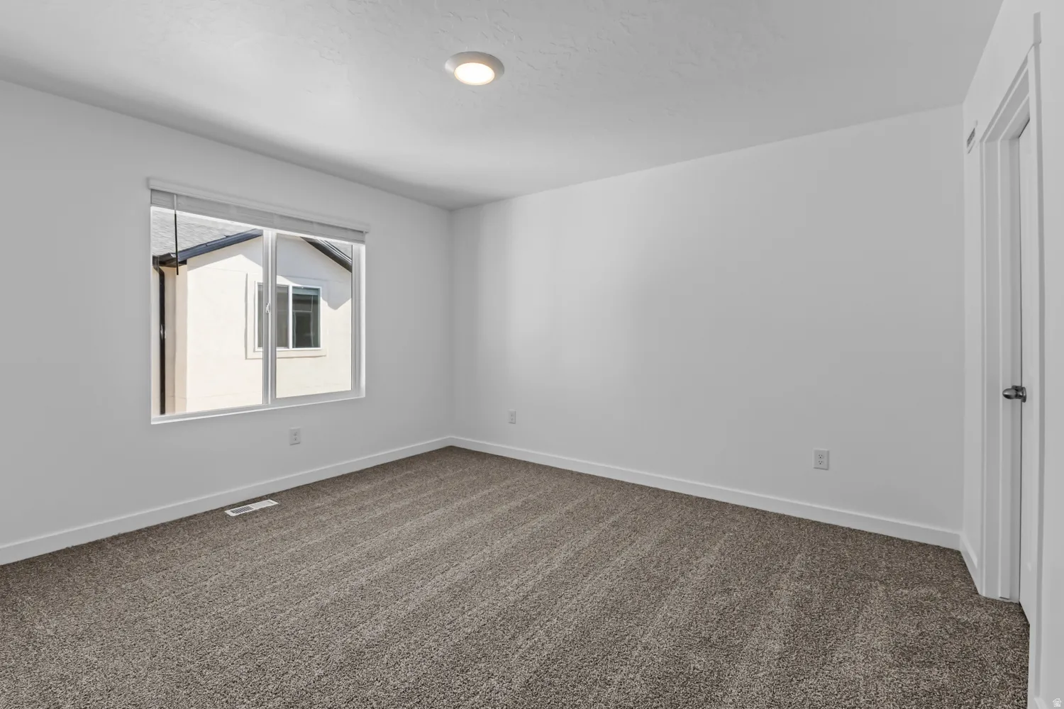 Neutral-toned carpeting throughout the room