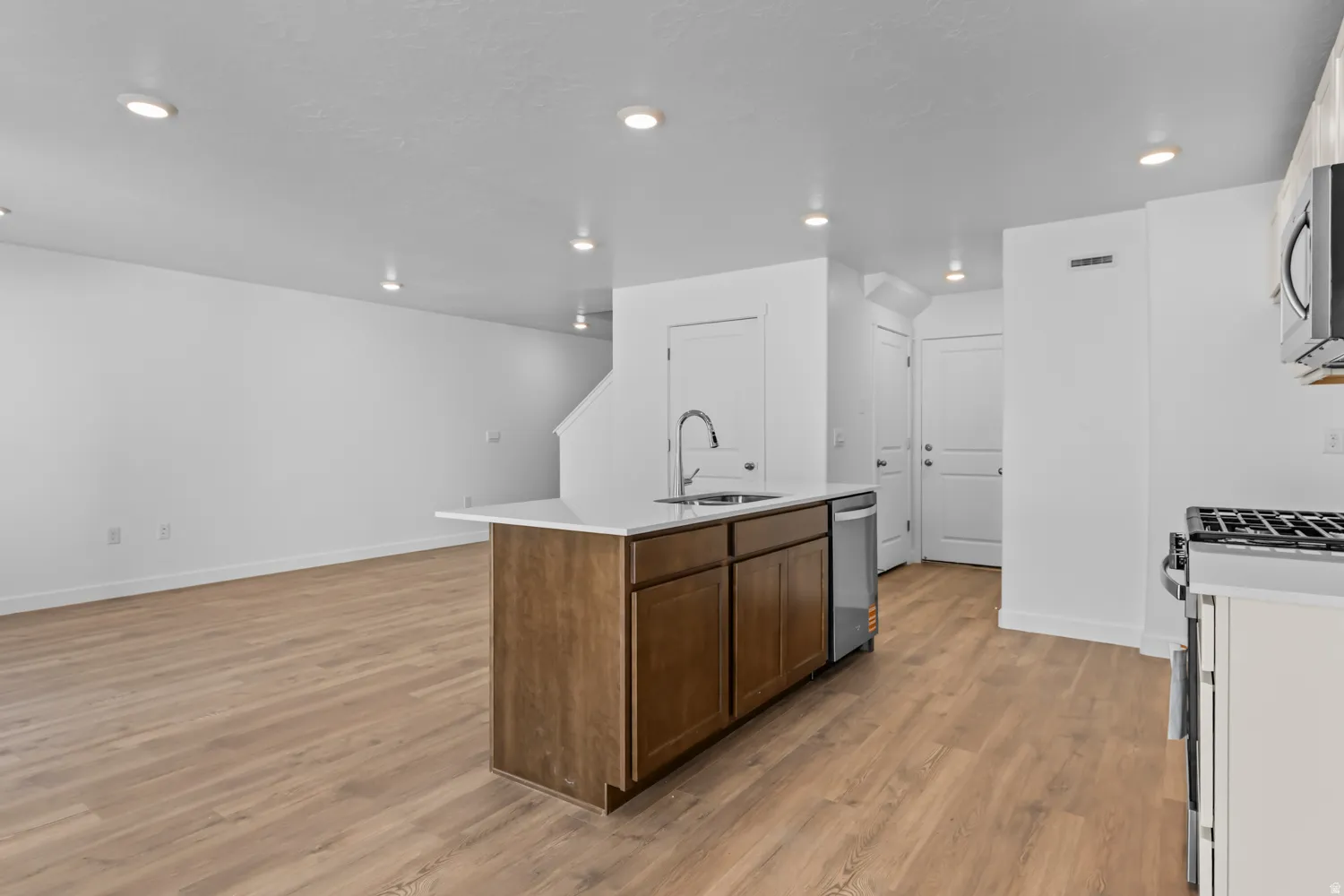 Open-concept living area featuring wood-finish flooring throughout