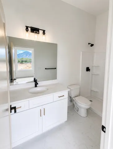 Contemporary bathroom featuring a white vanity with a light-toned countertop, an integrated sink, and a black faucet