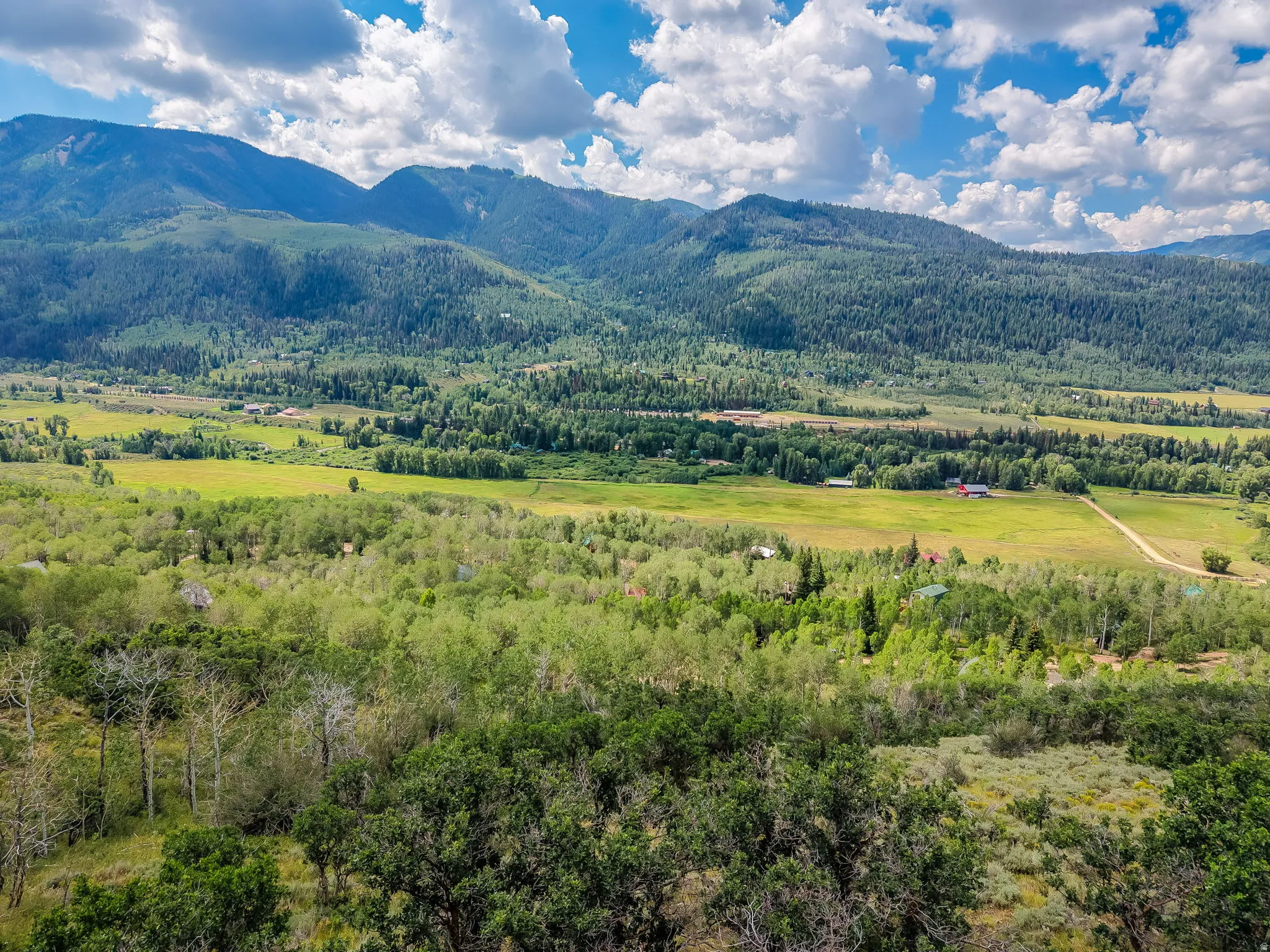 Expansive landscape featuring rolling hills and distant mountains