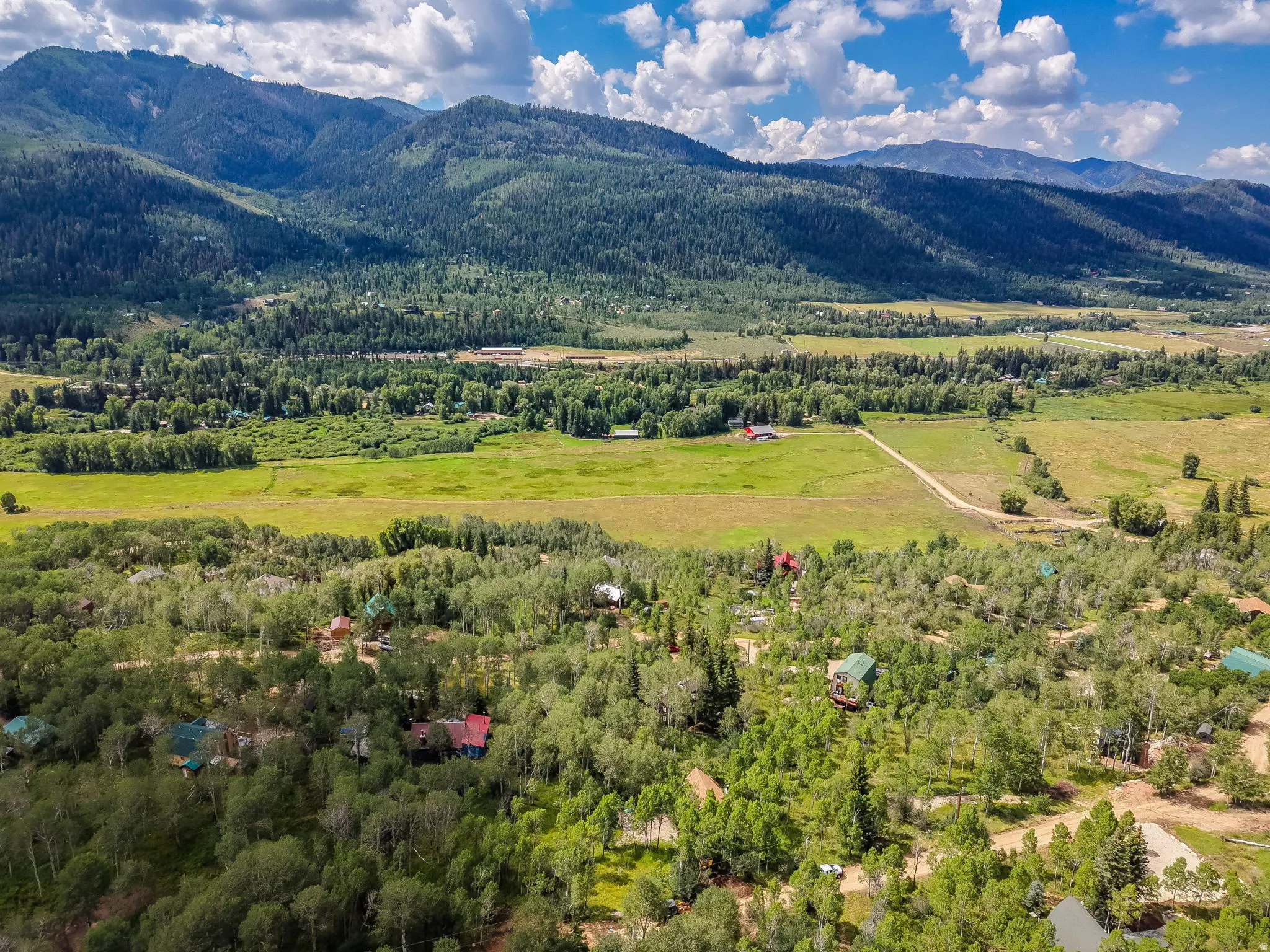 Expansive natural landscape featuring rolling hills and distant mountains