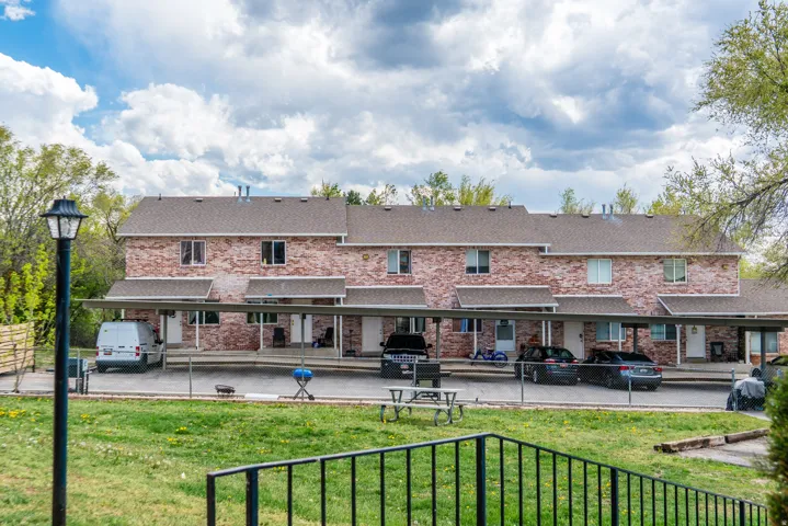 Brick facade townhome-style units featuring individual entrances and covered parking