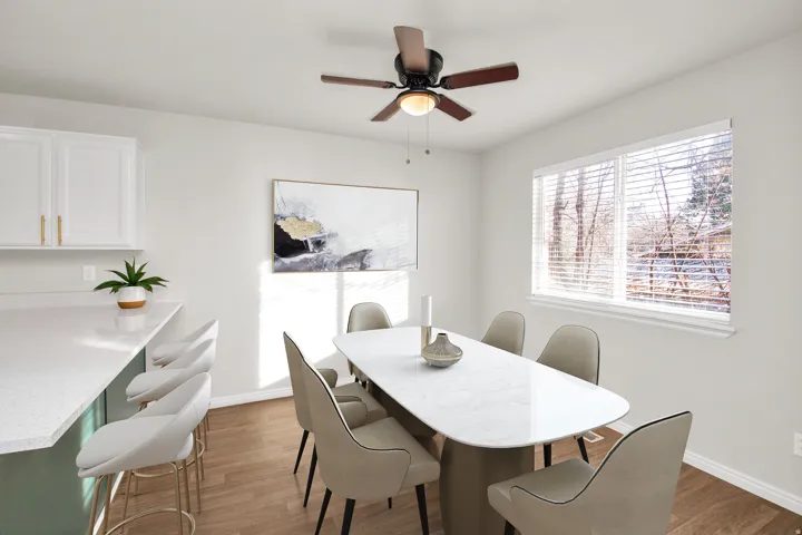 Dining area featuring wood-finish flooring and a ceiling fan with integrated lighting