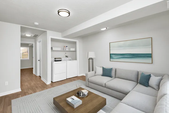 Open living area with wood-finish flooring and recessed lighting