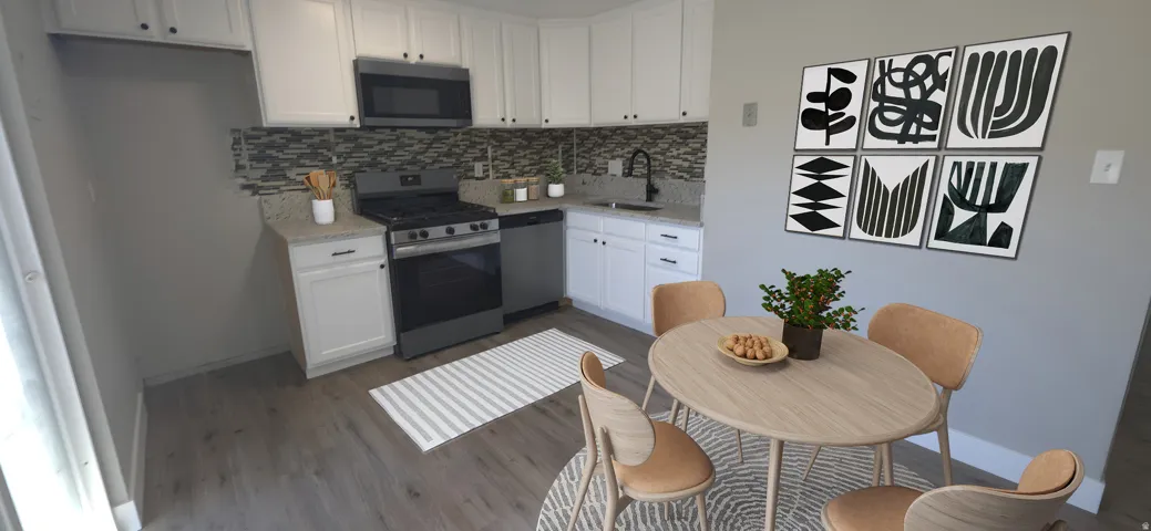 Contemporary kitchen featuring white cabinetry, granite-style countertops, a mosaic tile backsplash, stainless steel appliances, and wood-finish flooring