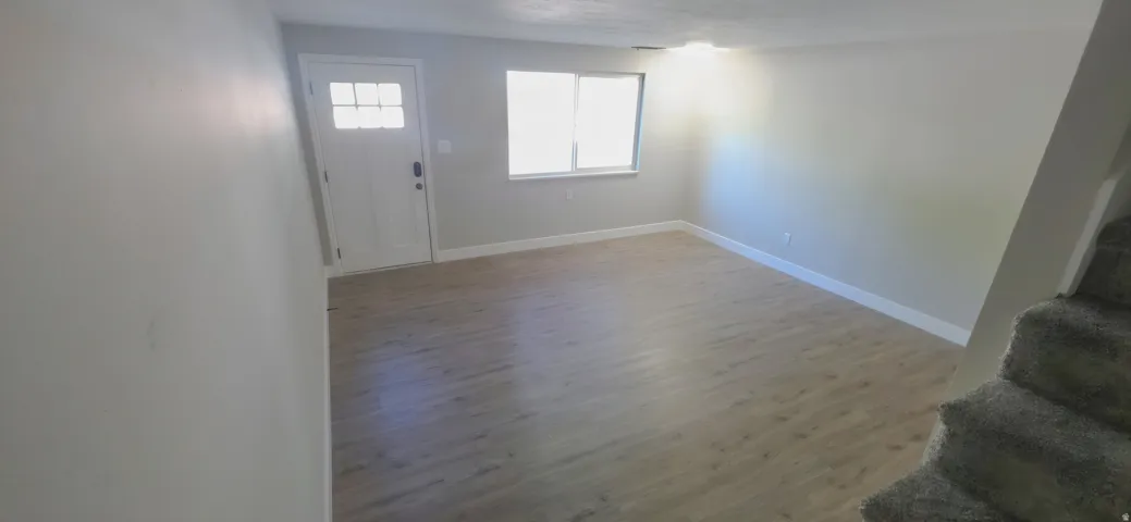 Bright living space featuring light wood-finish flooring