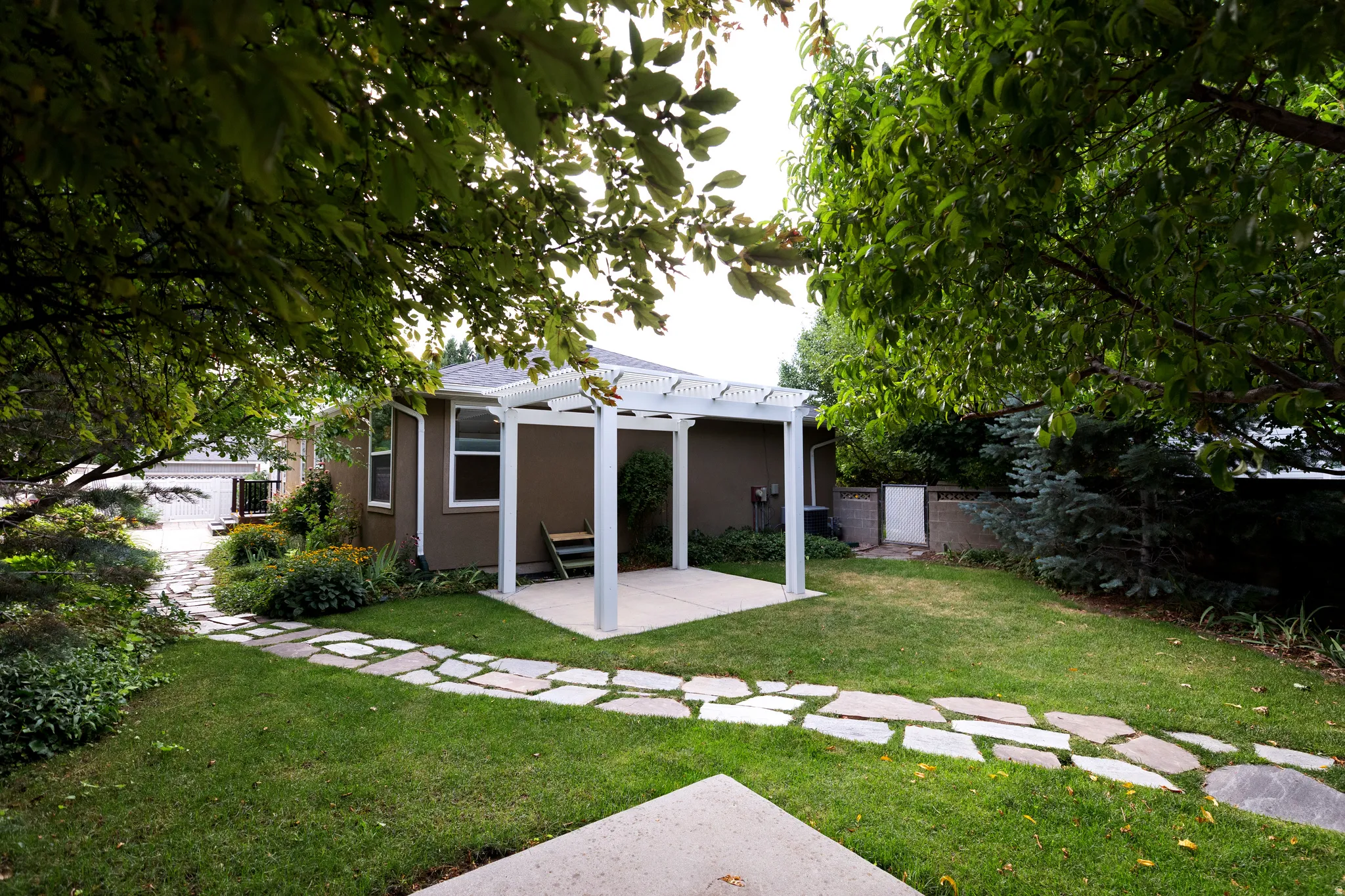 Expansive grassy lawn complemented by a flagstone pathway