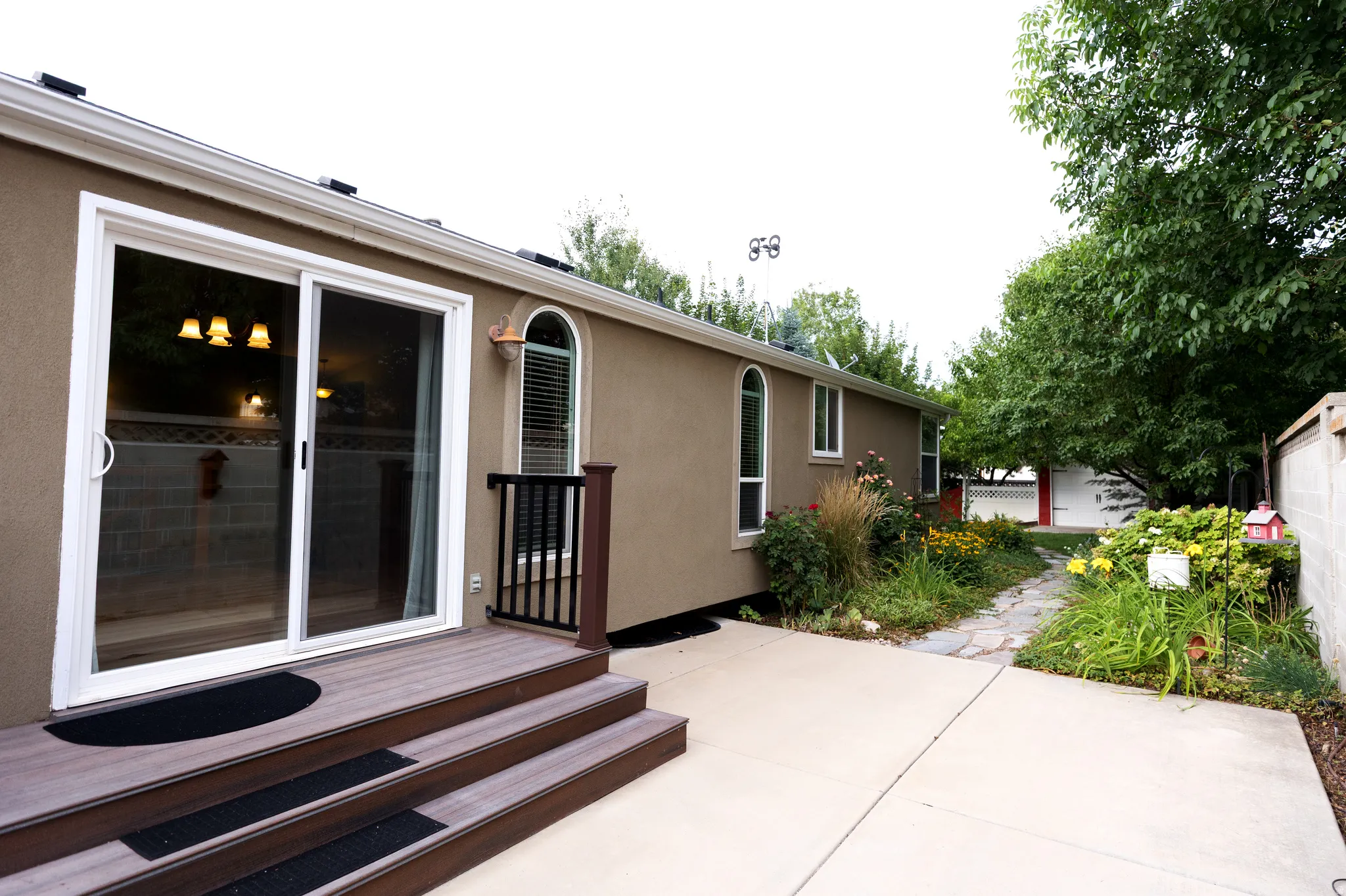 Sliding glass door opening to a three-step composite deck