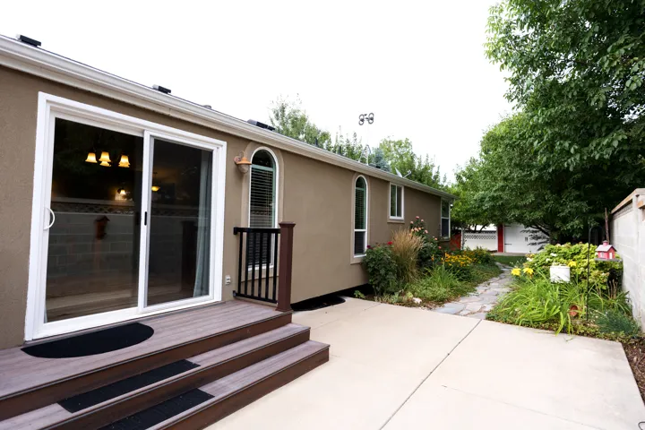 Sliding glass door opening to a three-step composite deck