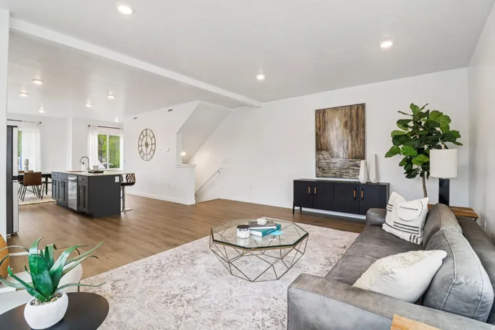 Expansive open-concept living area featuring wood-finish flooring, recessed lighting, and a neutral color palette