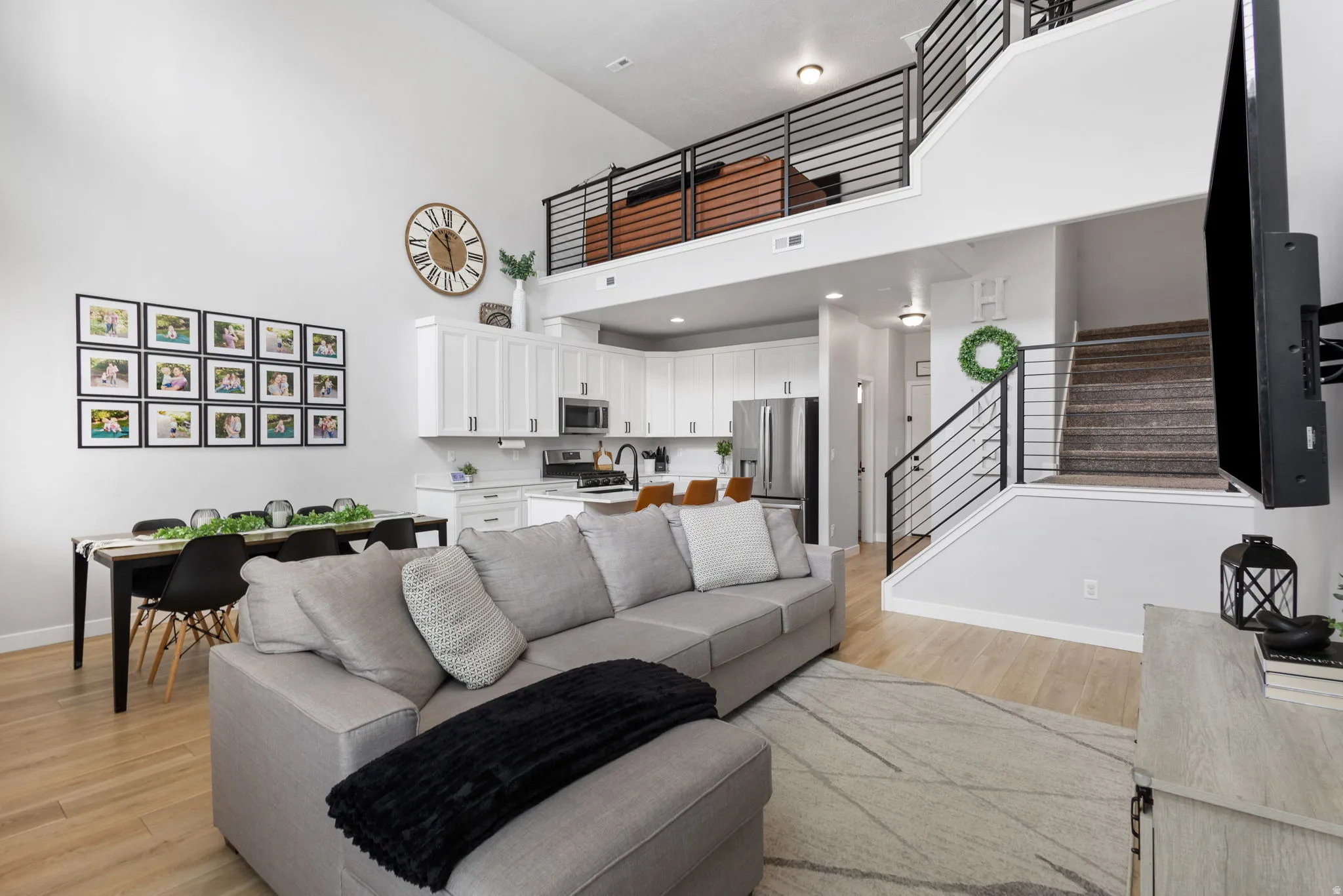 Open-concept living space featuring high ceilings and wood-finish flooring