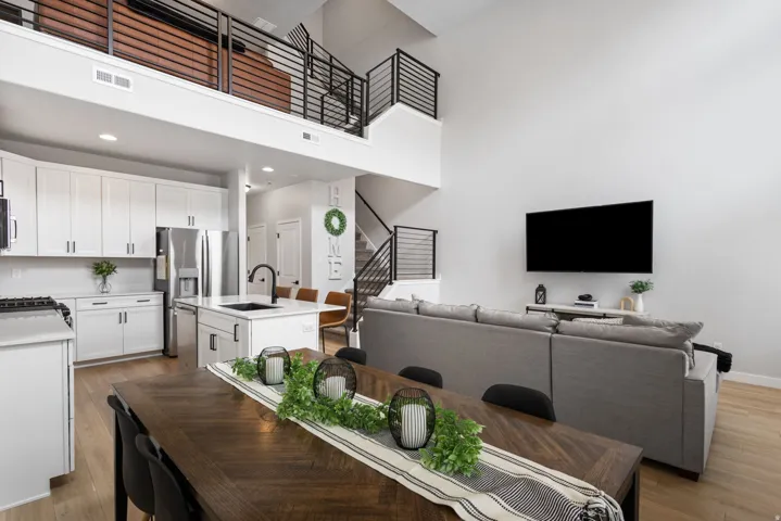 Open-concept living space with light wood-finish flooring