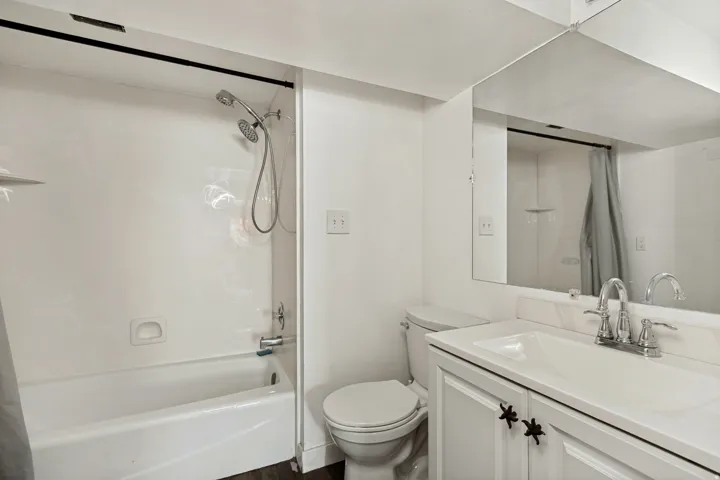 Bathroom featuring a built-in tub and shower combination with a handheld showerhead