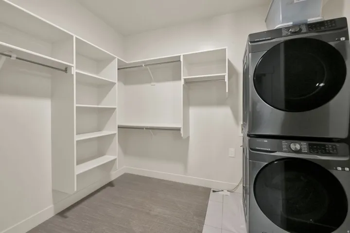 Primary Custom closet organization system with multiple shelving units and hanging rods