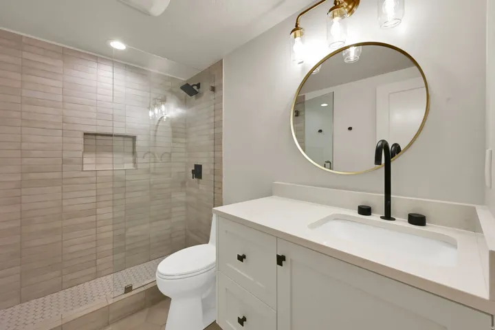 Bathroom featuring a glass-enclosed shower with subway tile surround and a tiled niche