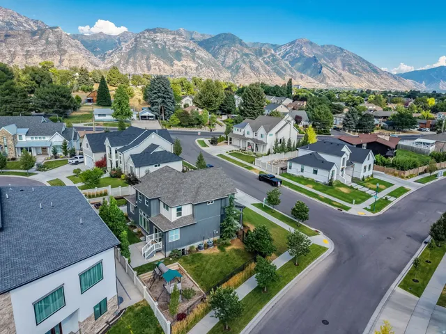 Modern residential neighborhood featuring paved streets, sidewalks, and manicured landscaping