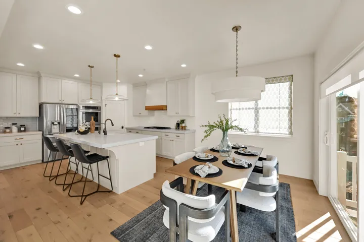 Open-concept kitchen and dining area featuring light wood-finish flooring