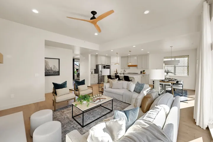 Expansive living area with recessed lighting and wood-finish flooring