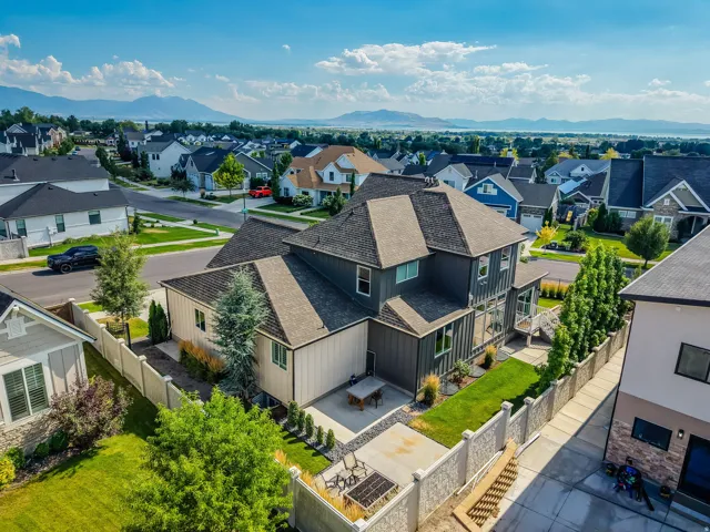 Contemporary residence featuring dark gray and light beige siding with a multi-gabled roofline