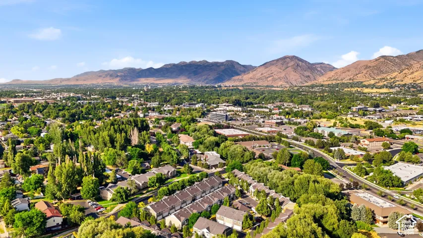 Expansive community featuring mature trees, diverse residential architecture, and a prominent mountainous backdrop