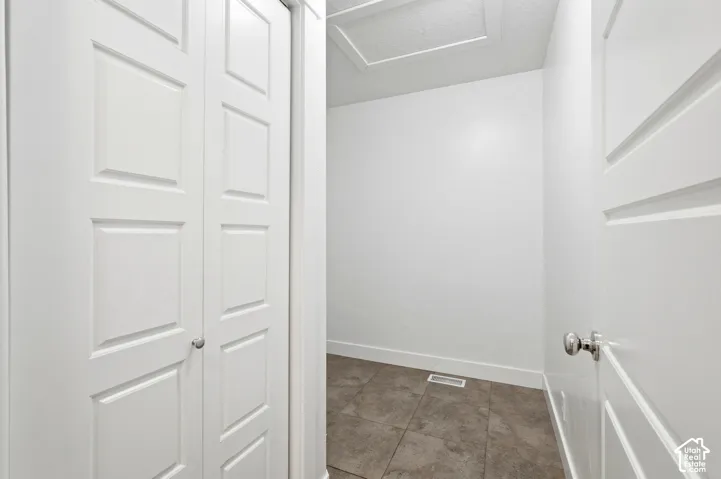 White interior space featuring bi-fold panel doors and a solid panel door with chrome hardware