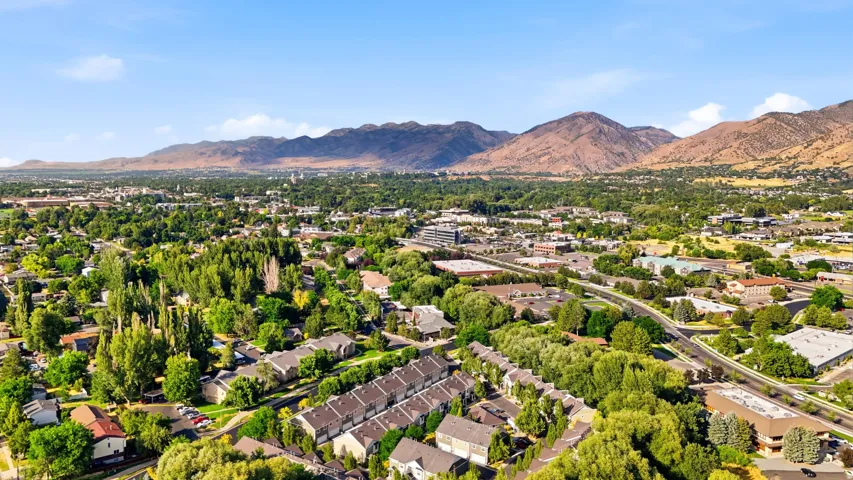 Expansive community featuring mature trees, diverse residential architecture, and a prominent mountainous backdrop