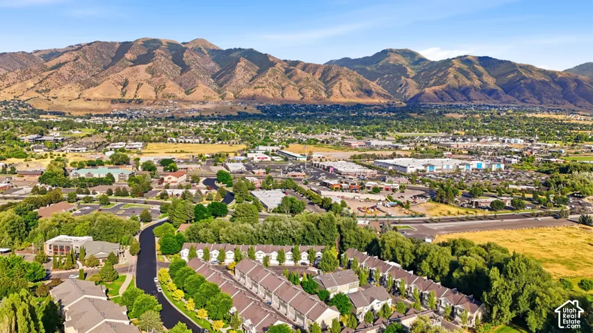 Expansive aerial perspective showcasing a residential community nestled against a prominent mountain range