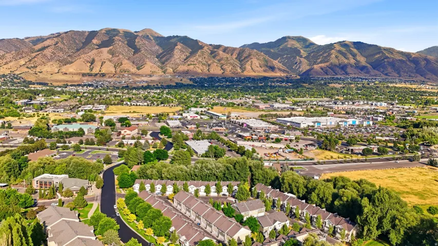 Expansive aerial perspective showcasing a residential community nestled against a prominent mountain range