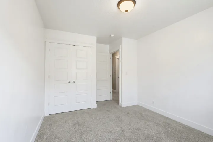 Neutral tone walls complementing gray carpeting
