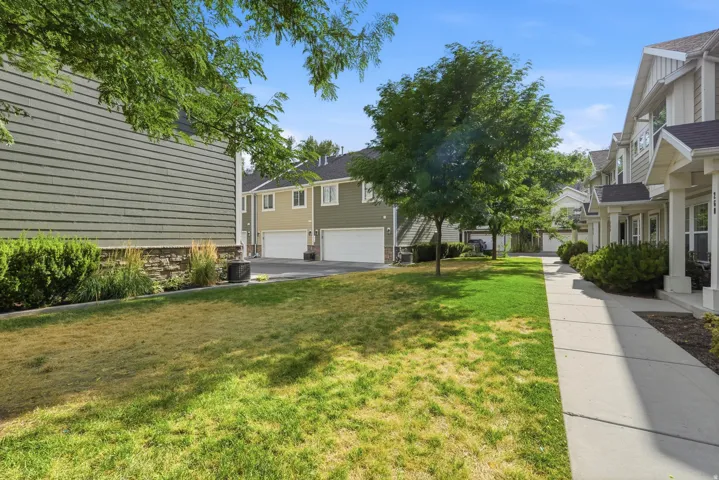 Exterior perspective showcasing a row of residential properties with siding facades