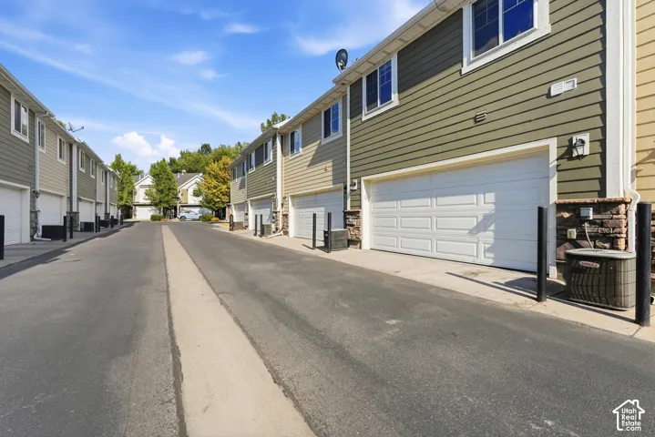Property exterior featuring horizontal siding, white paneled garage door, and stone accents