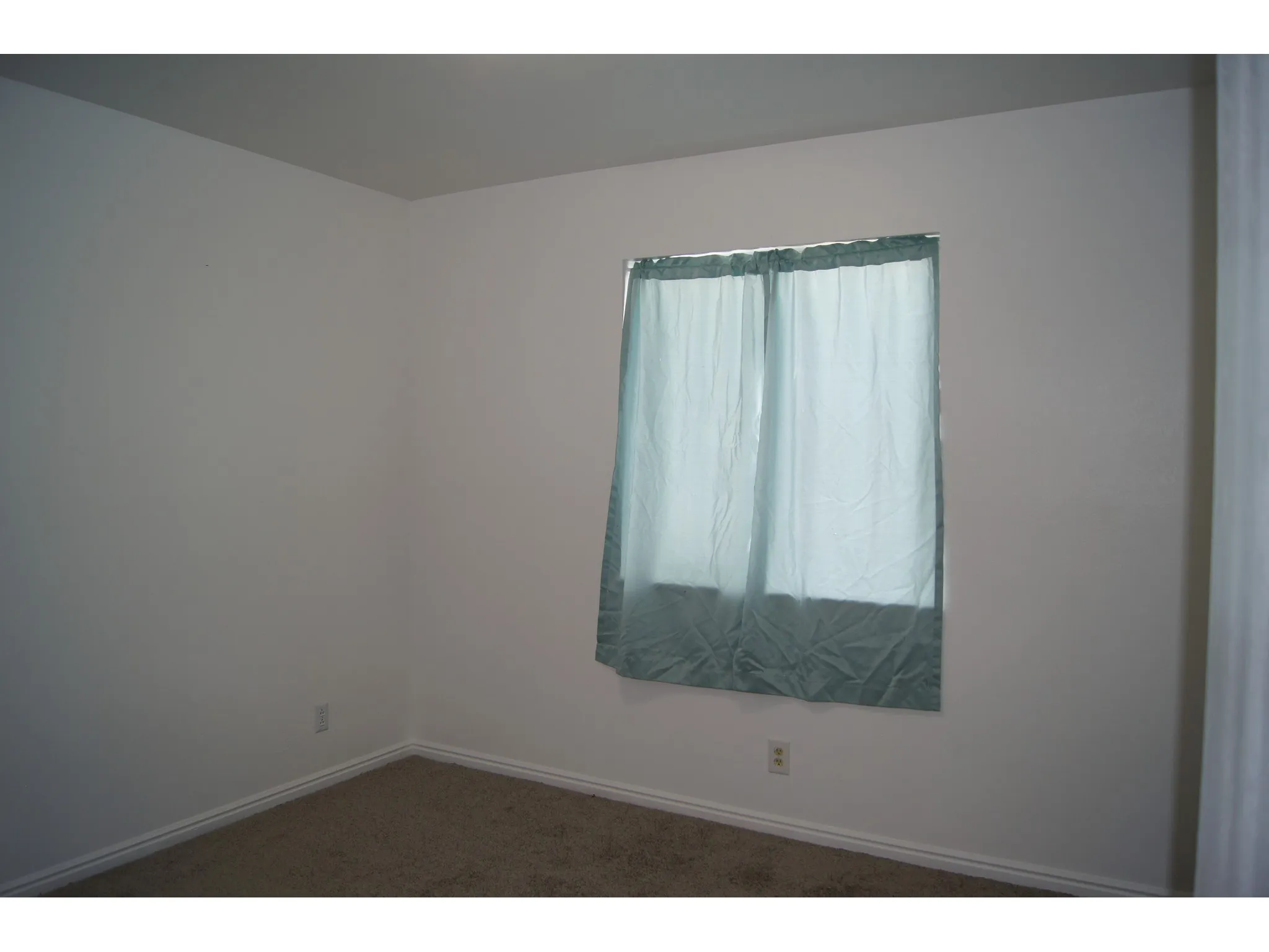 Bedroom 2 White walls with baseboard trim and carpeted flooring