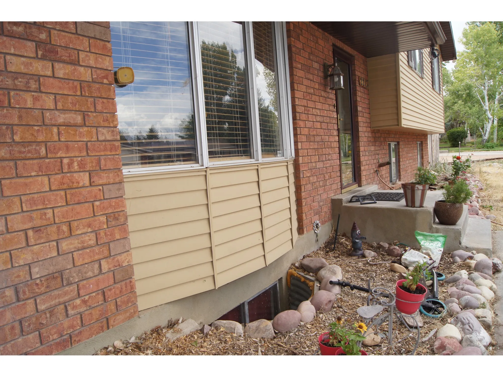 Brick and siding exterior featuring a prominent bay window
