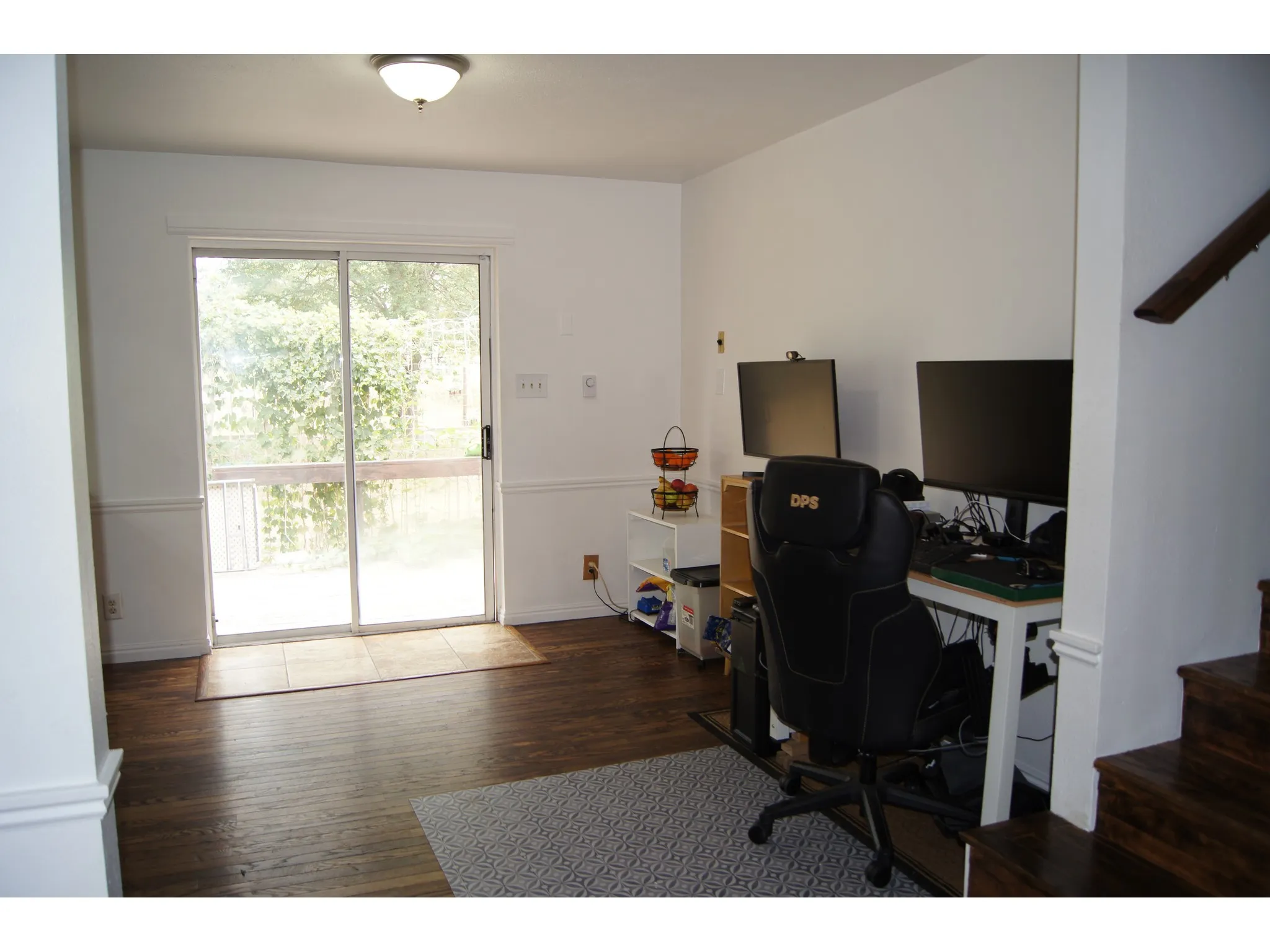 Bright interior space featuring wood-finish flooring and a ceiling-mounted light fixture