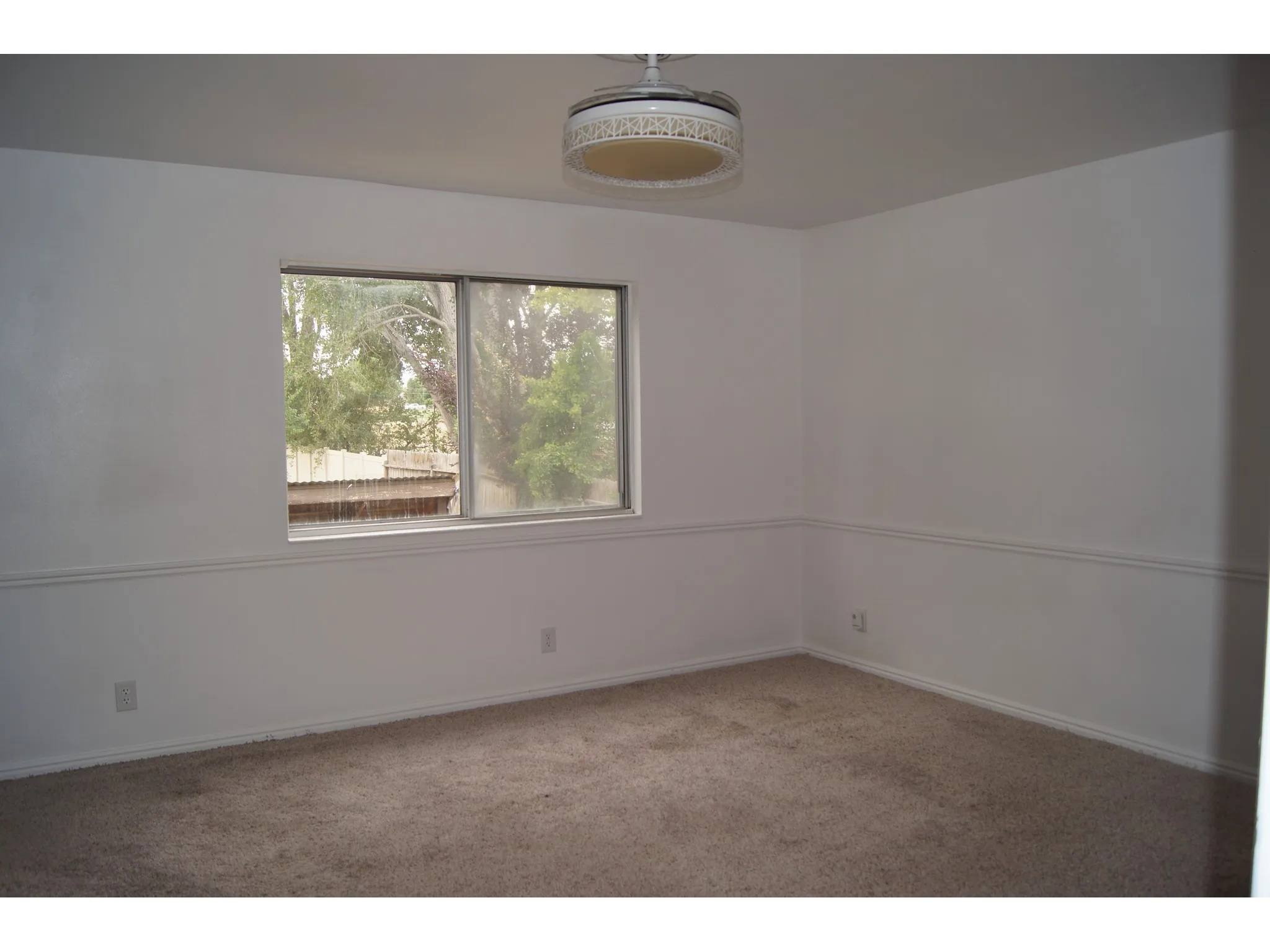 Master Bedroom Room featuring a window with exterior tree and fence scenery