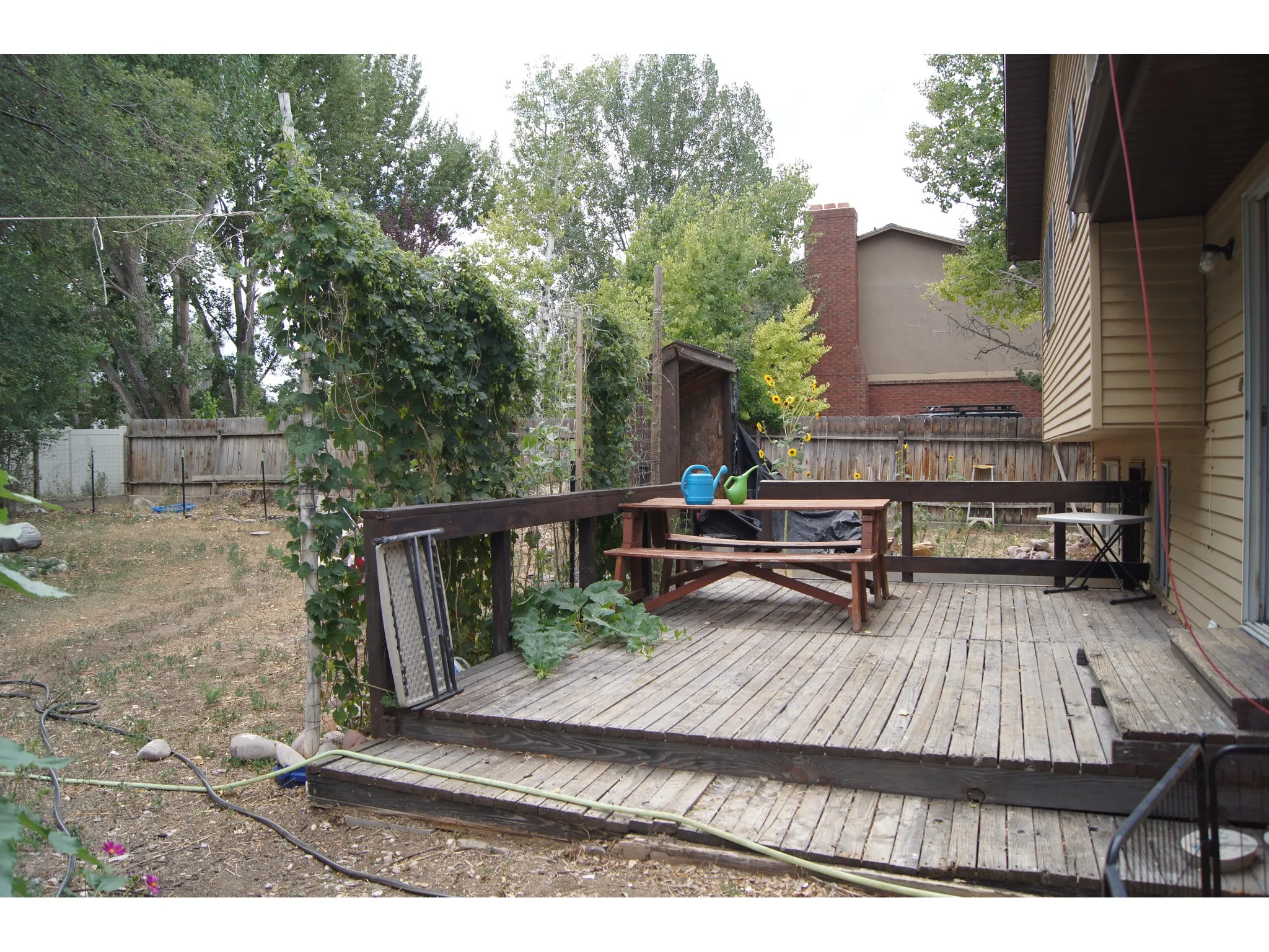 Expansive outdoor deck featuring wood flooring and a sliding glass door for interior access