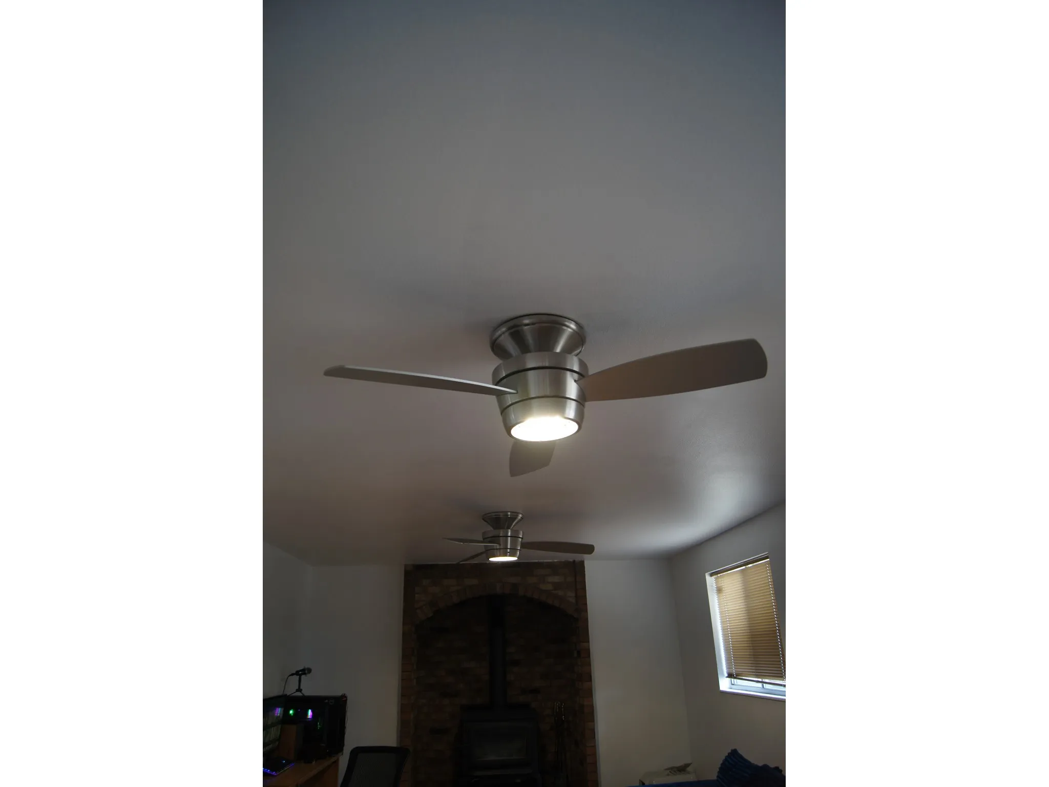 Dual ceiling fans with integrated lighting fixtures
