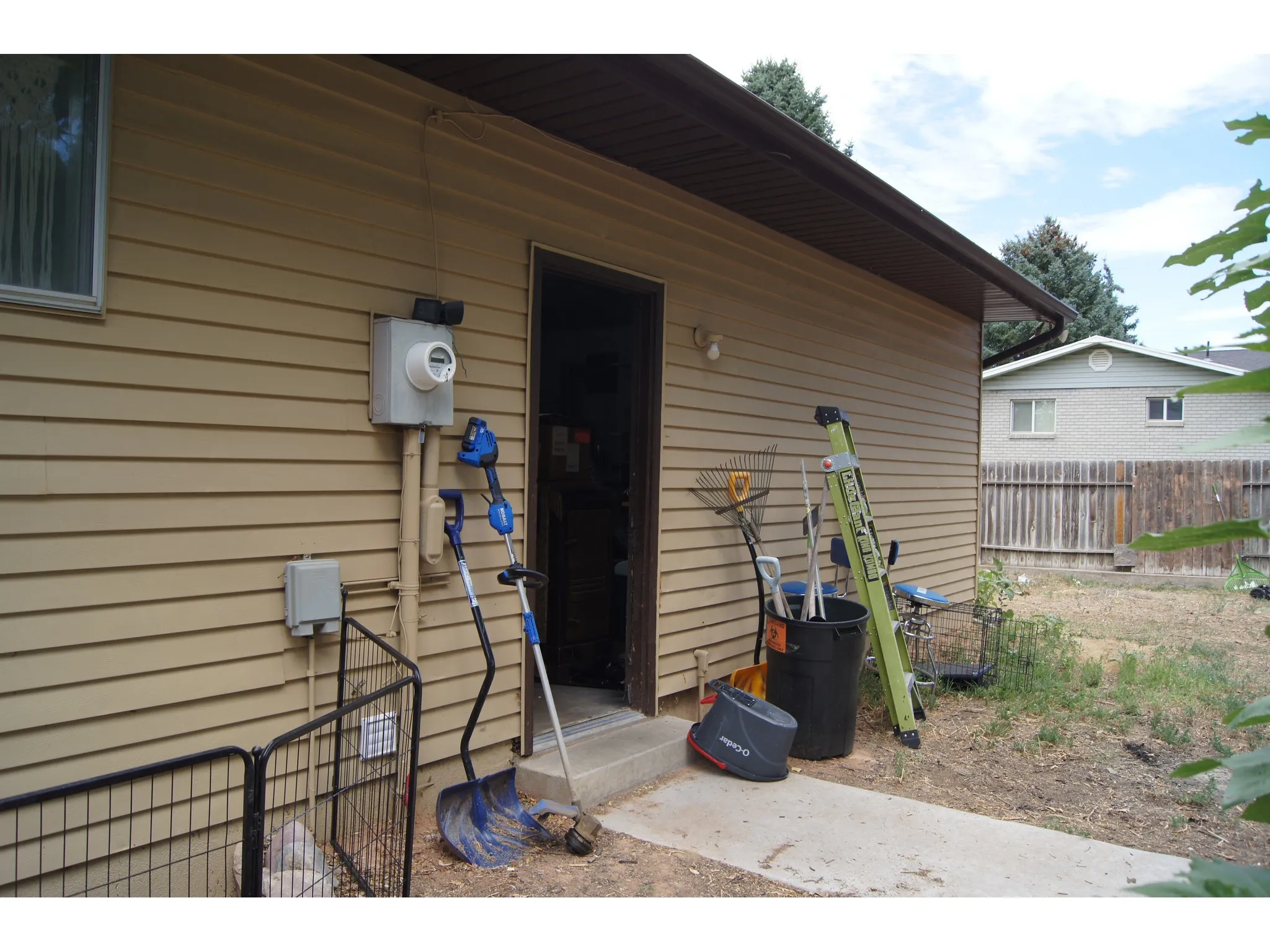 Exterior siding with a door leading into the garage