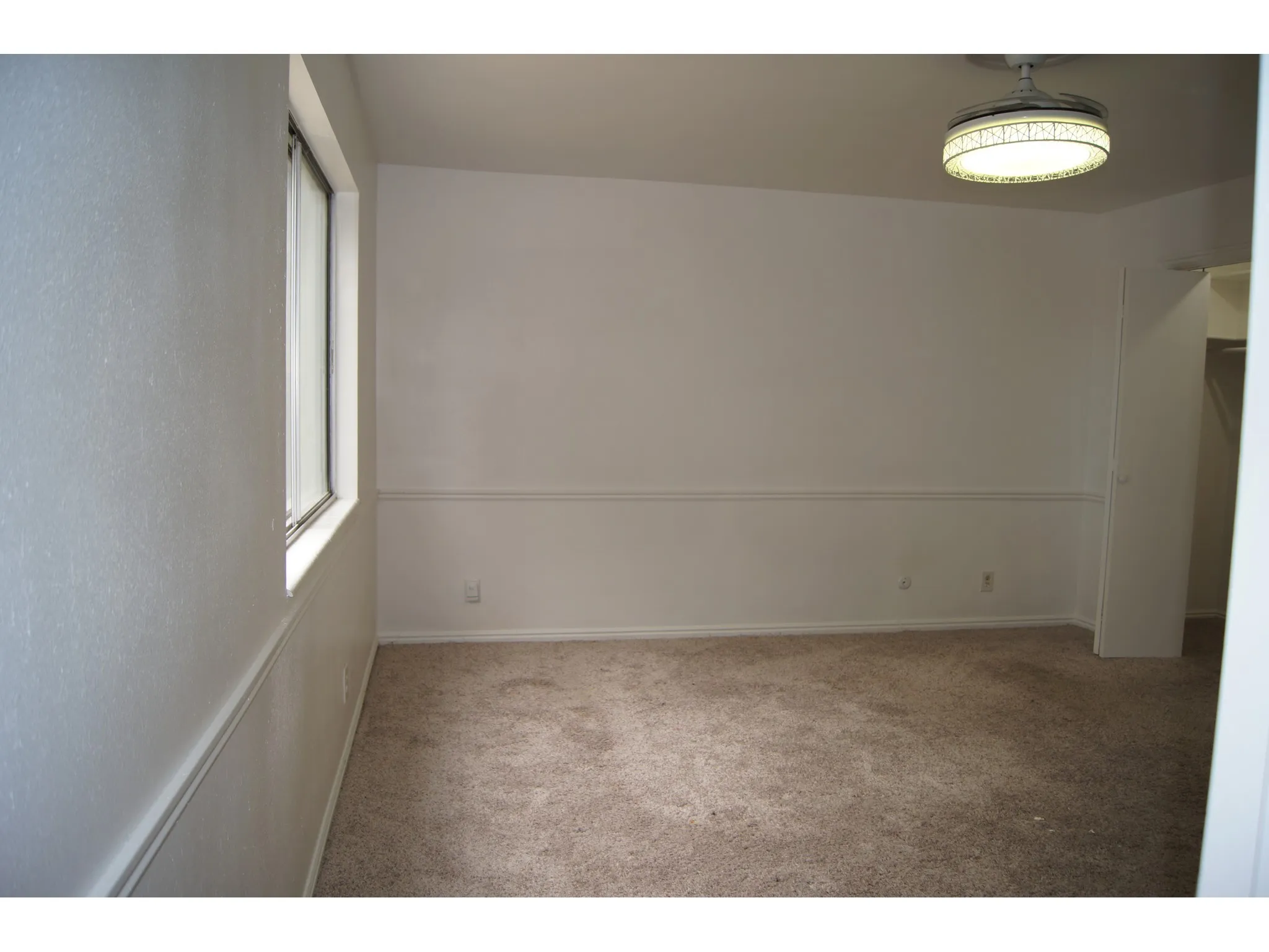 Master Bedroom Neutral wall color with chair rail molding and textured wall finish